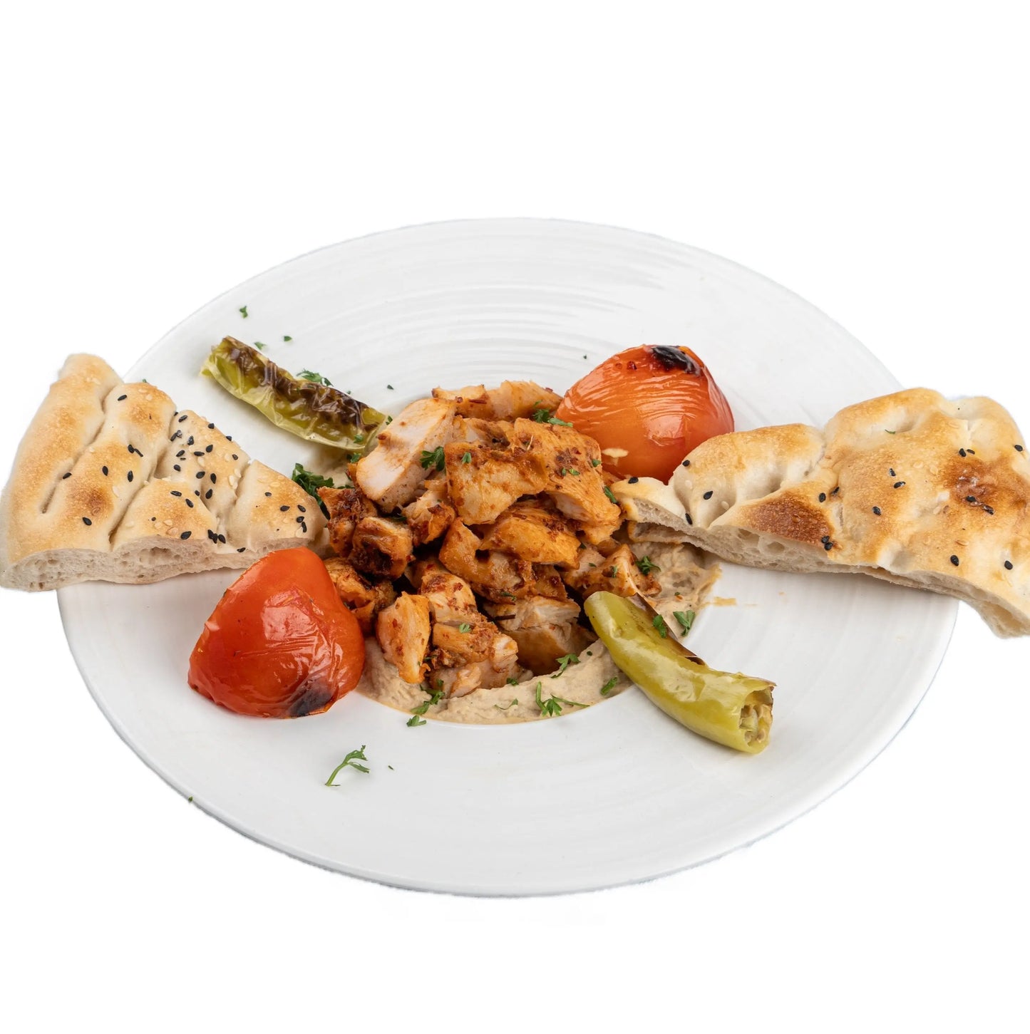 Creamy hummus topped with grilled chicken, served with fresh herbs and spices at Anatolia Turkish Restaurant Singapore