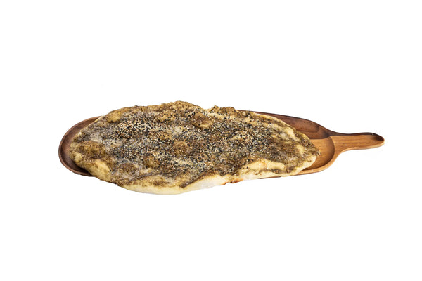 Freshly baked zaatar bread served on a wooden board at Anatolia Turkish Restaurant in Singapore