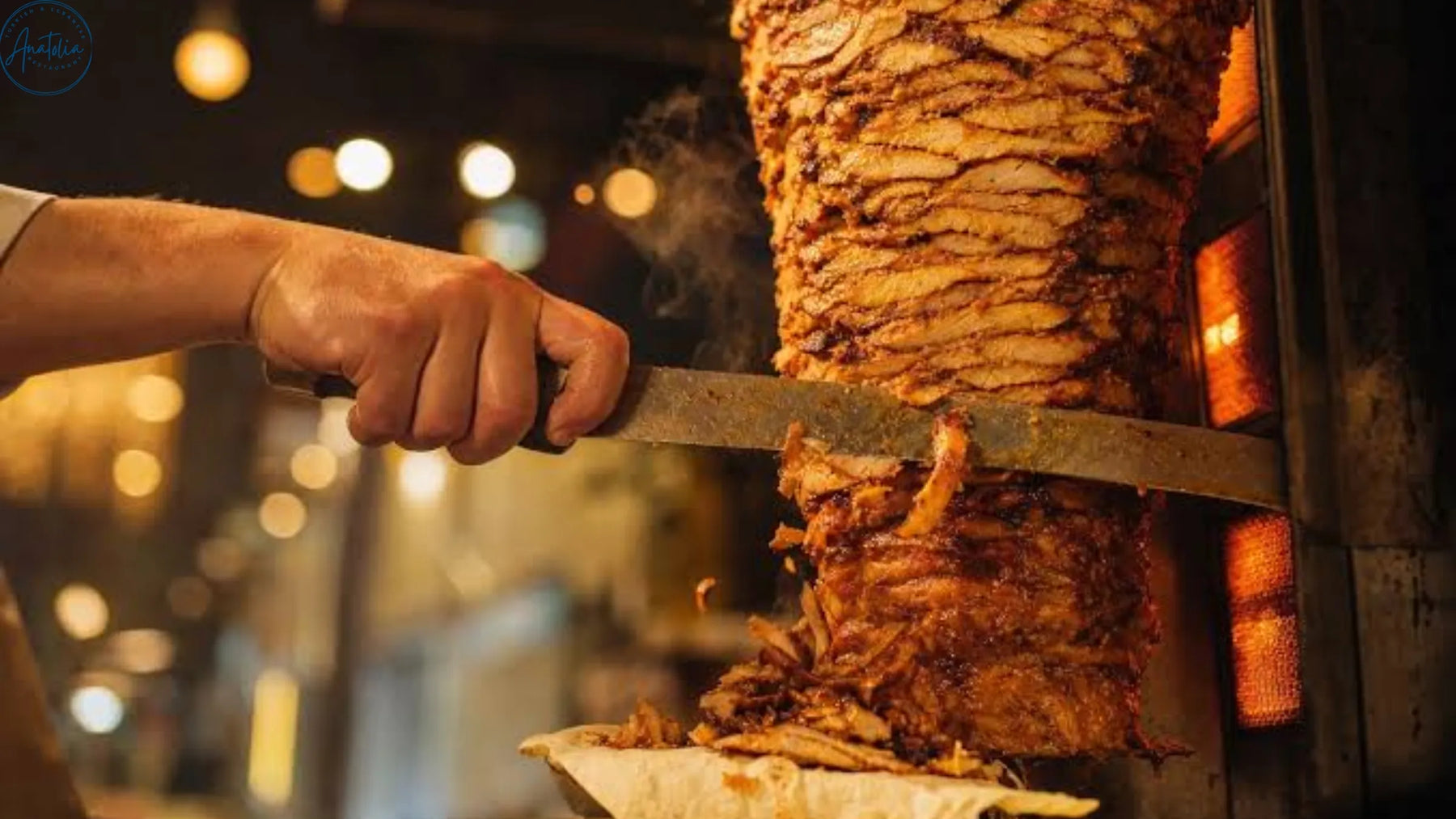 Meat being shaved from a vertical rotisserie at Anatolia Restaurant
