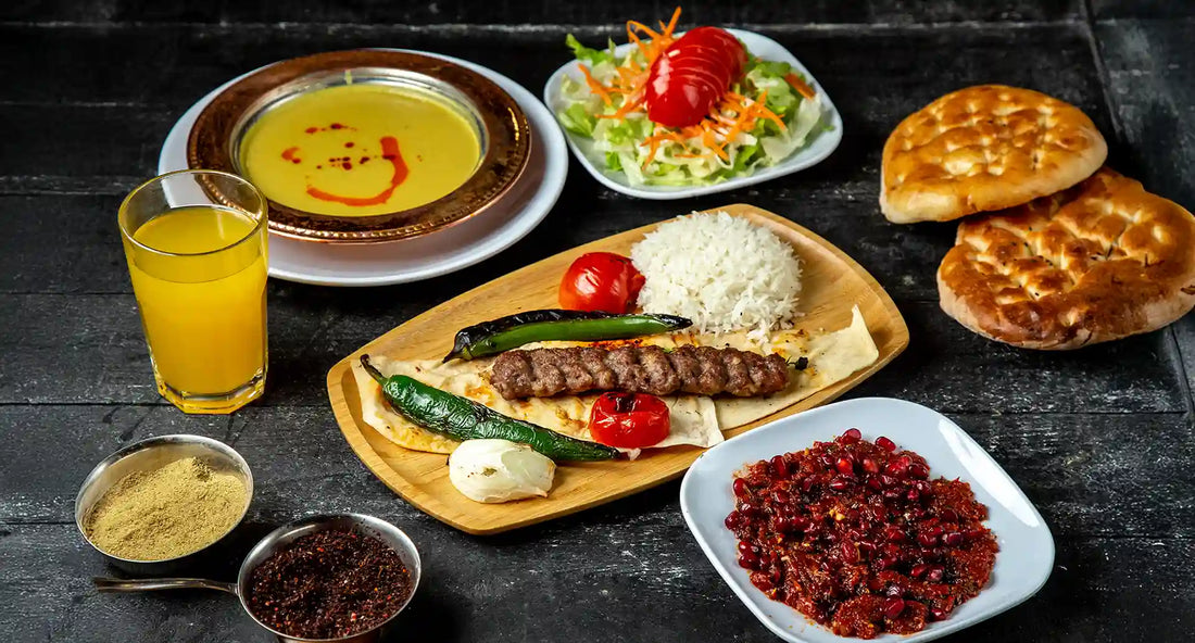 Authentic Turkish cuisine Singapore feast at Anatolia Restaurant featuring Adana kebab, lentil soup, fresh salad, spicy ezme, and warm flatbread.