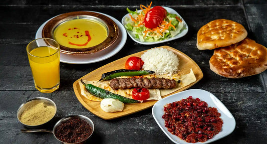 Authentic Turkish cuisine Singapore feast at Anatolia Restaurant featuring Adana kebab, lentil soup, fresh salad, spicy ezme, and warm flatbread.