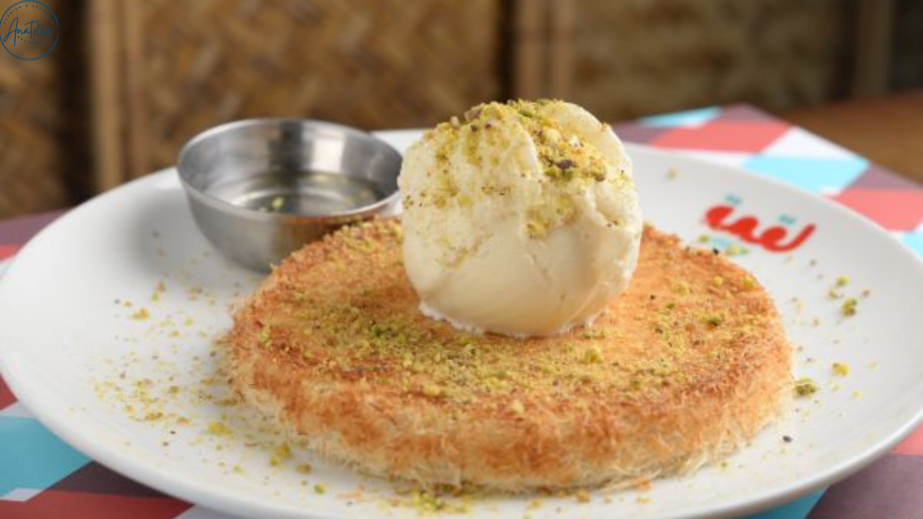 Hot kunafa topped with crushed pistachio served at Anatolia Restaurant