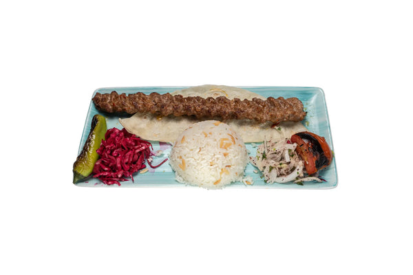 Adana lamb kebab served with grilled vegetables and rice at Anatolia Restaurant