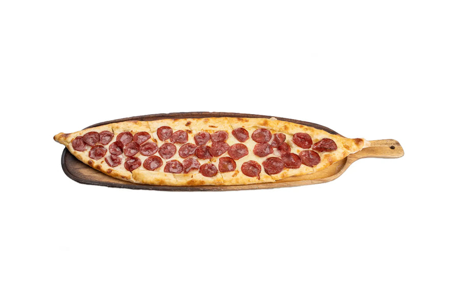 Pepperoni pide served on a wooden board at Anatolia Restaurant Singapore