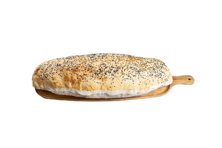 Turkish balloon bread served on a wooden paddle at Anatolia Restaurant Singapore