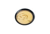 Traditional creamy soup with freshly cut bread slices and lemon, served in an elegant black bowl.